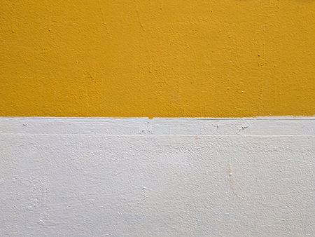 Yellow and white painted cement wall. Abstract background and texture for design.の写真素材