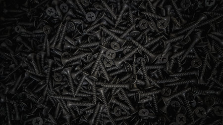 Many black screws arranged in a row. Industrial background. 3d rendering