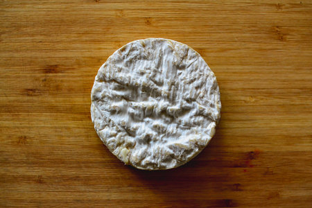 Camembert cheese on a wooden board. Top view. Copy space.の写真素材
