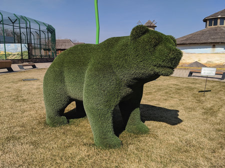 Sculpture of a bear made of grass in the parkの写真素材