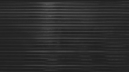 Close up of black corrugated metal sheet texture background with horizontal stripes