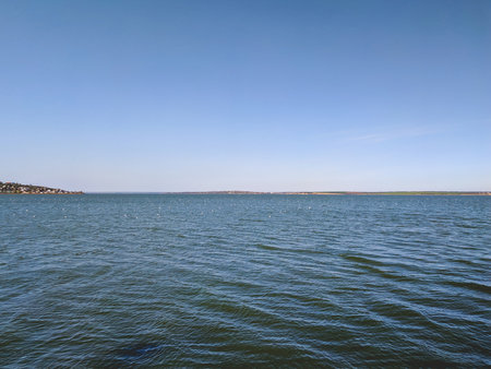 View of the sea from the shore, blue sky and white cloudsの写真素材