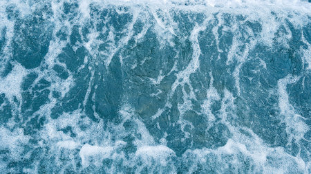 Close up of blue sea water with foam and waves. Nature backgroundの写真素材