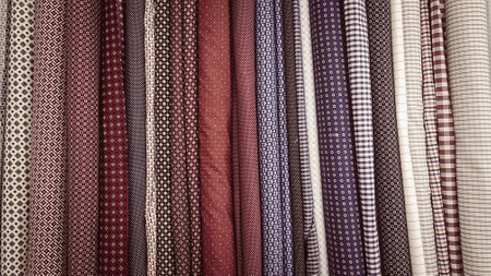 Close-up of colorful checkered shirts in a shop windowの写真素材