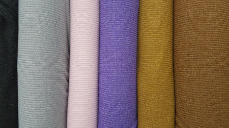 Fabric samples of different colors for sale in a shop or storeの写真素材
