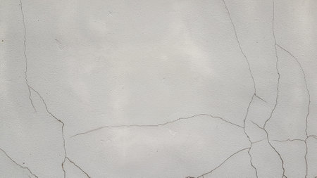 White concrete wall with cracks and scratches. Abstract background for design.の写真素材
