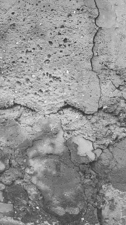 black and white texture of old cracked concrete wall. background for designの写真素材