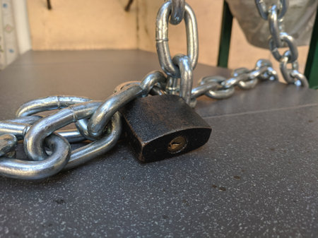 Padlock and chain on a table in a cafe, closeup of photo