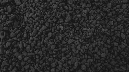 Black pebbles background. Black pebbles texture. Natural pebbles background.