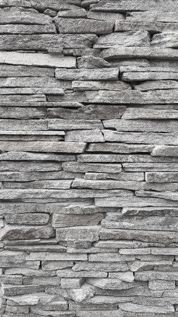 Background of stone wall texture. Black and white tone. Copy space.の写真素材