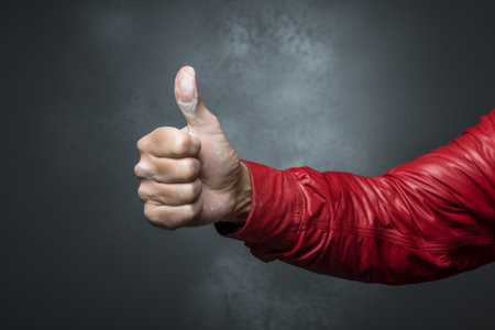 Close up of man's hand showing thumbs up sign with copy spaceの素材