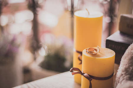engagement wedding rings with candels backgroundの写真素材