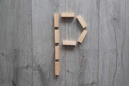 letter P with wooden natural blocks, construction, game for kids, no stress with wooden blocks, backgroundの写真素材