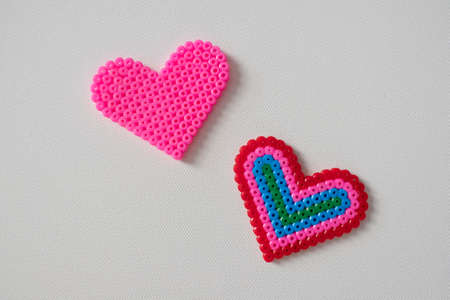 thermo mosaic ready-made figurines in the form hearts colorful and pink on white backgroundの写真素材