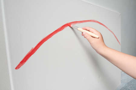 kid drawing red line art with paints rainbowの写真素材