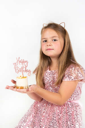 girl sitting on blue background with confetti celebrationの写真素材