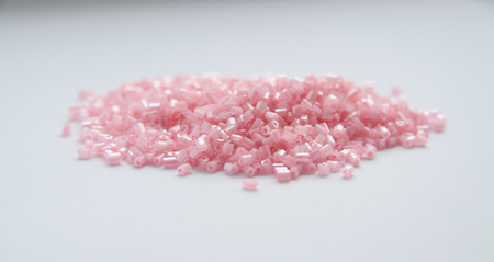 Pink beads for craft on isolated background
