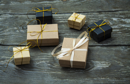 small different Christmas gift boxes on a rustic wooden backgroundの写真素材