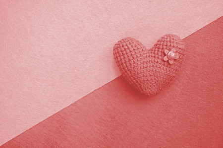 knitted heart, love symbol, living coral, color of the 2019 year, pink backgroundの写真素材