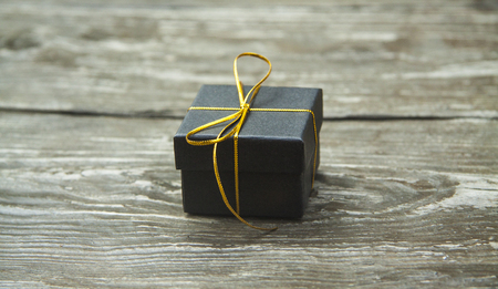 small different Christmas gift boxes on a rustic wooden background