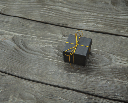 small different Christmas gift boxes on a rustic wooden backgroundの写真素材