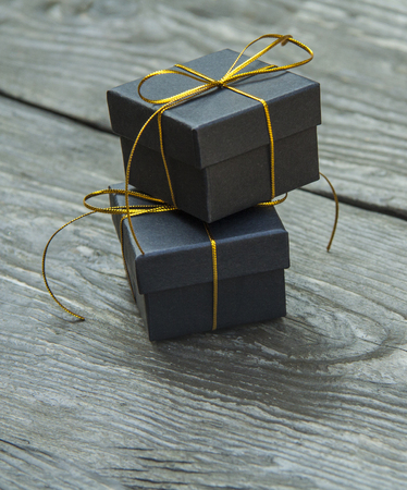 small different Christmas gift boxes on a rustic wooden backgroundの写真素材