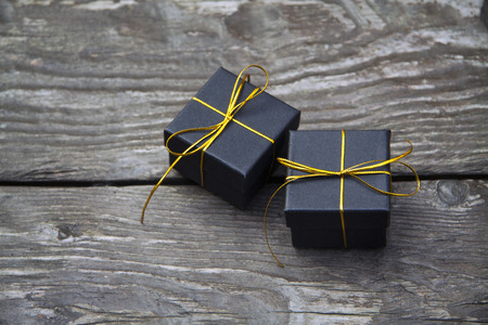 small different Christmas gift boxes on a rustic wooden background