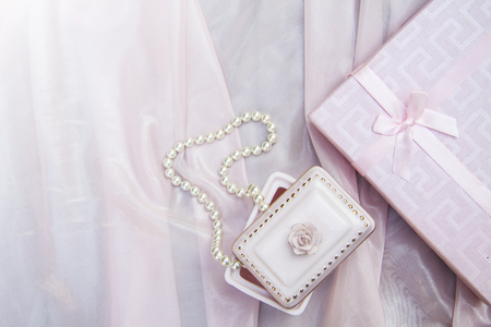 pink background with gift box and pearl beads and a rose, mother's dayの写真素材