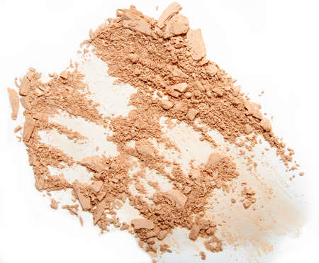 crumbled beige powder and brush stroke isolated on white backgroundの写真素材