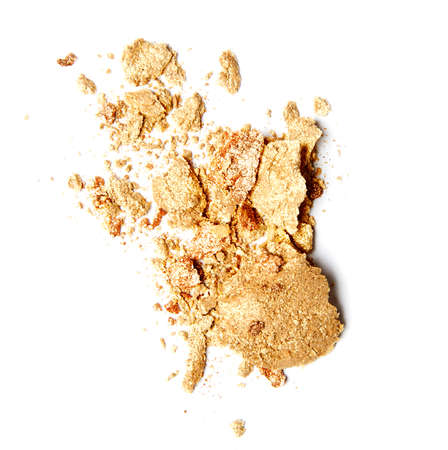 yellow gold crumbled eyeshadow isolated on white backgroundの写真素材
