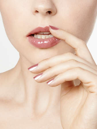 woman close up with pink lipstick and nail polishの写真素材