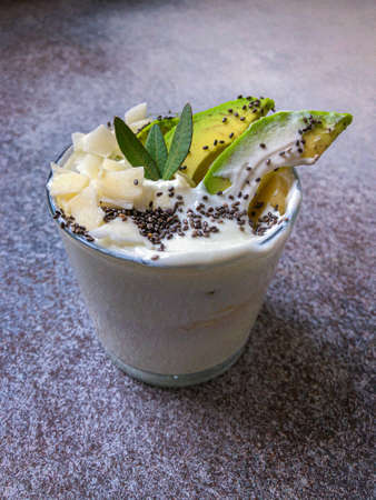 smoothie with avocado topped chia seeds and coconut chips