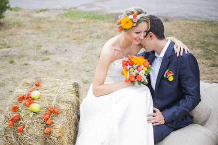 Young couple in wedding gown. Bride holding bouquet of flowers.の写真素材