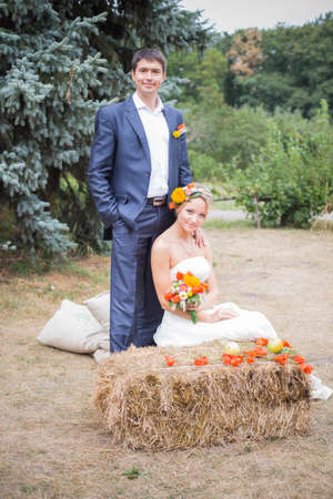 Young couple in wedding gown. Bride holding bouquet of flowers.の写真素材