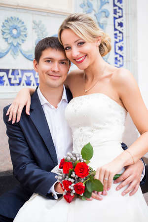 Young couple in wedding gown. Bride holding bouquet of flowers.の写真素材
