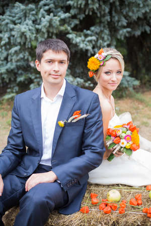 Young couple in wedding gown. Bride holding bouquet of flowers.の写真素材