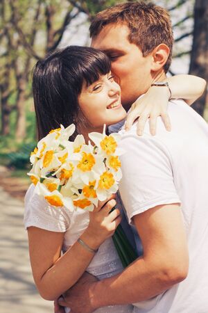 Beautiful loving caucasian couple on a date walking at the park. summer warm weatherの写真素材