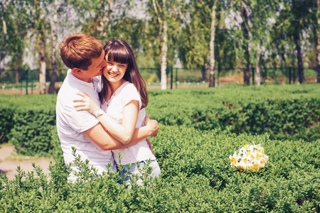 Beautiful loving caucasian couple on a date walking at the park. summer warm weatherの写真素材