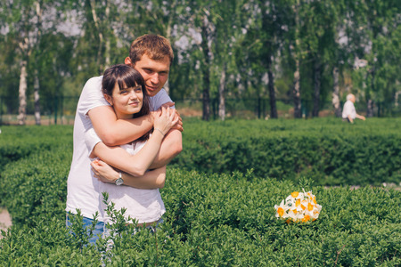 Beautiful loving caucasian couple on a date walking at the park. summer warm weatherの写真素材
