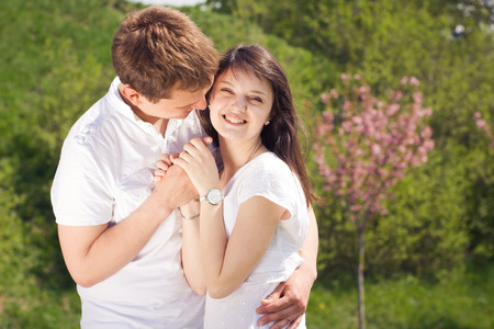 Beautiful loving caucasian couple on a date walking at the park. summer warm weatherの写真素材