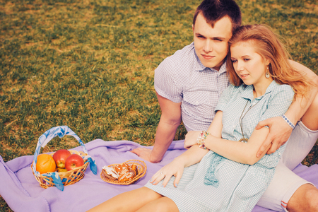 Beautiful loving caucasian couple on a date walking at the park. summer warm weatherの写真素材