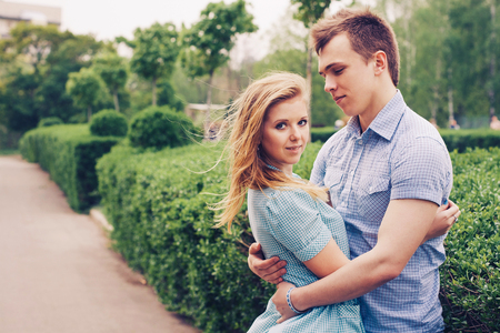 Beautiful loving caucasian couple on a date walking at the park. summer warm weatherの写真素材