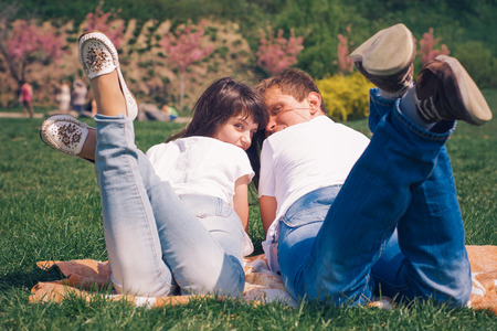 Beautiful loving caucasian couple on a date walking at the park. summer warm weatherの写真素材