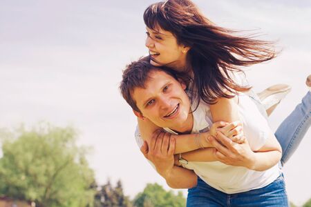 Beautiful loving caucasian couple on a date walking at the park. summer warm weatherの写真素材