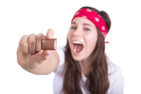 Piece of chocolate in woman's hand isolatedの写真素材