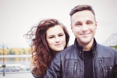 Couple hugging and smiling outdoorsの写真素材