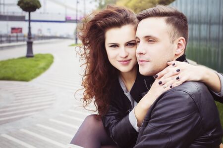 Couple hugging and smiling outdoorsの写真素材