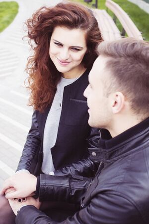 Couple holding hands and smiling outdoorsの写真素材