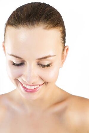 Brunette woman with natural make up with highlights isolatedの写真素材