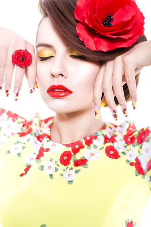 Close up of a woman. beauty make up concept with poppy theme: red lips, yellow eye shadows and poppy nail designの写真素材